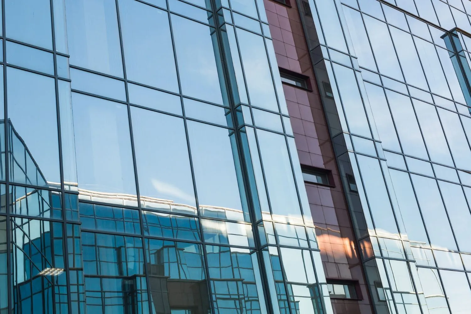 A tinted glass curtain wall on a modern office building.